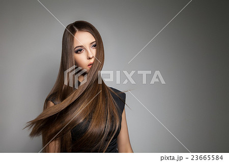 Brunette model with brilliant hair flying away Brunette model with brilliant hair flying away 23665584