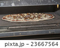 Pizza baking in the oven 23667564