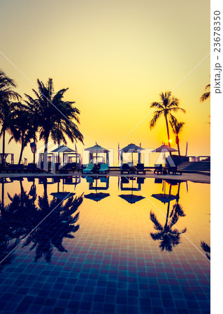 Beautiful Silhouette palm tree with umbrella and chair 23678350