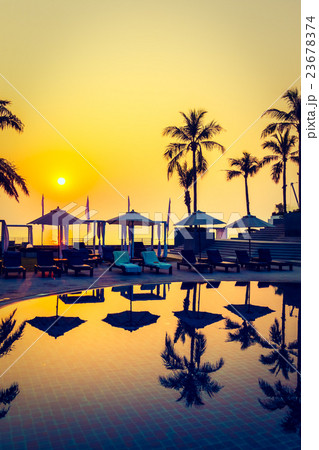Beautiful Silhouette palm tree with umbrella and chair 23678374