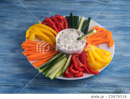 Plate of colorful vegetable sticks with dip sauce Plate of colorful vegetable sticks with dip sauce 23679516