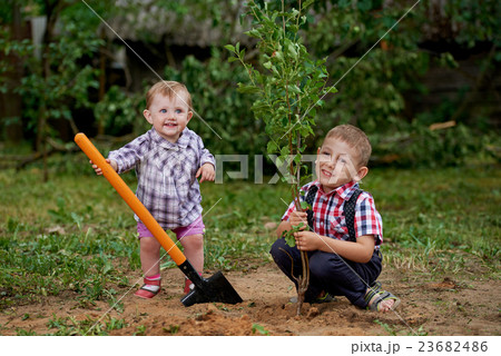 funny boy with shovel in garden funny boy with shovel in garden 23682486