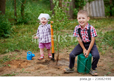 funny boy with shovel in garden funny boy with shovel in garden 23682490