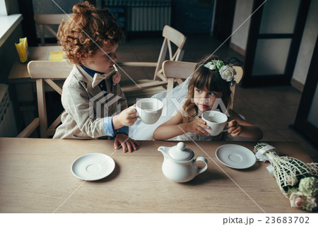 boy and girl having tea party in cafe boy and girl having tea party in cafe 23683702