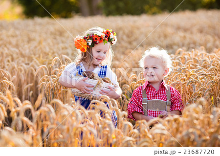 Kids in Bavarian costumes in wheat field Kids in Bavarian costumes in wheat field 23687720