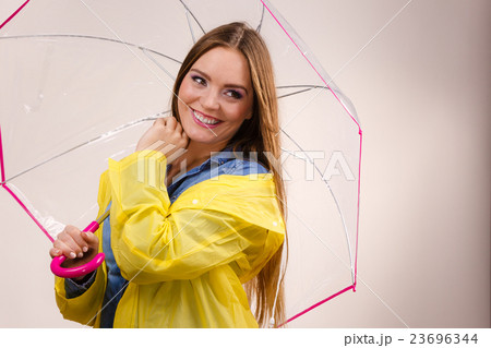 Woman wearing waterproof coat under umbrella Woman wearing waterproof coat under umbrella 23696344