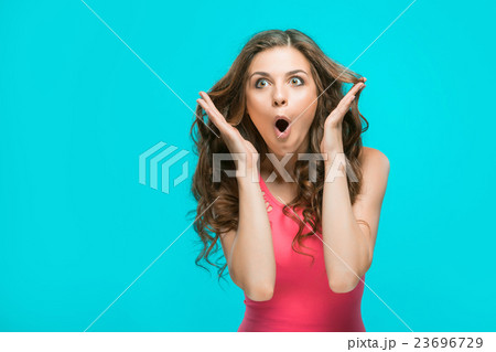 Portrait of young woman with shocked facial Portrait of young woman with shocked facial 23696729