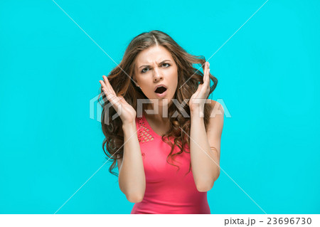 Portrait of young woman with shocked facial 23696730