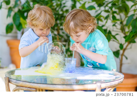 Two happy children making experiment with colorful 23700781