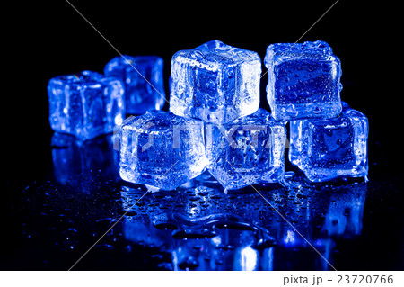 ice cubes in blue light on a black table. 23720766