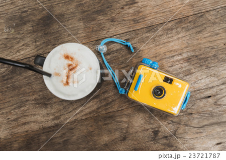 camera with coffee in cafe on wood table camera with coffee in cafe on wood table 23721787