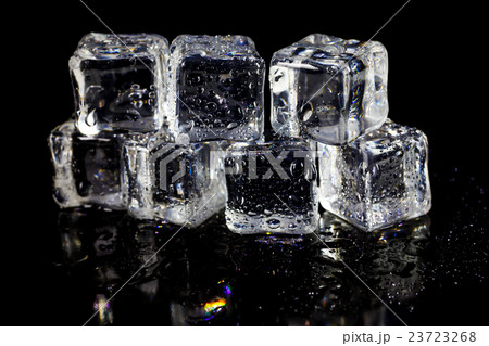 ice cubes reflection on black table background. 23723268