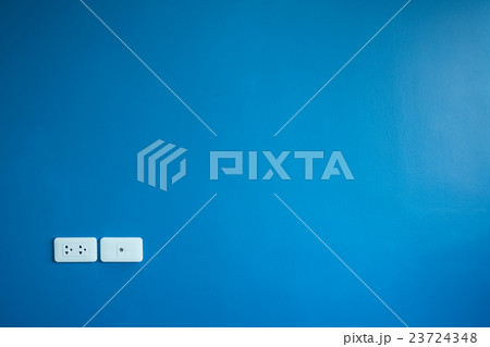 Power outlet on blue wall 23724348