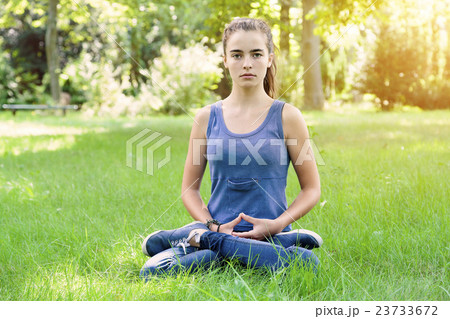 beautiful teenage girl meditates in a garden beautiful teenage girl meditates in a garden 23733672