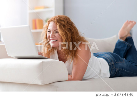 Joyful woman using laptop 23734346