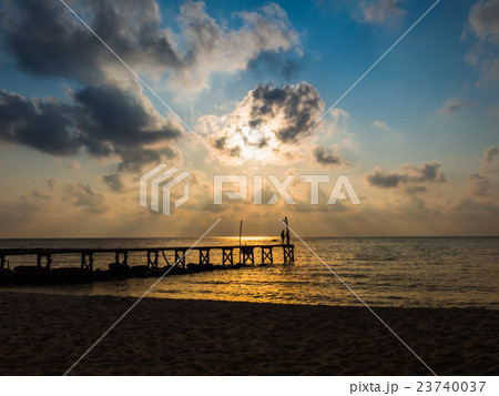 Wooded bridge to the sea between sunset Wooded bridge to the sea between sunset 23740037
