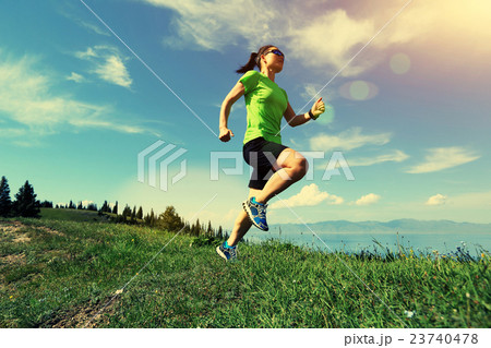 young woman trail runner running on mountain peak young woman trail runner running on mountain peak 23740478