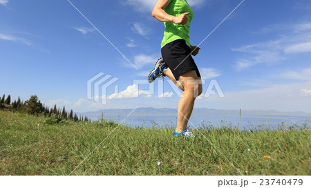 young woman trail runner running on mountain peak young woman trail runner running on mountain peak 23740479
