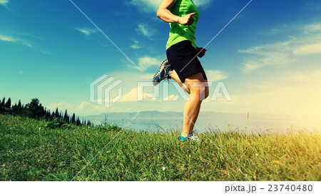 young woman trail runner running on mountain peak young woman trail runner running on mountain peak 23740480