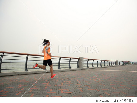young asian woman runner running on seaside 23740485