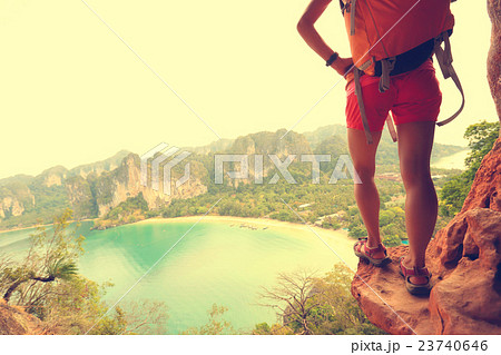 young woman backpacker  at seaside mountain cliff 23740646
