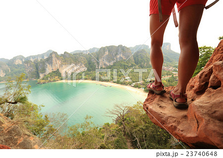 woman hiker enjoy the view at mountain peak cliff woman hiker enjoy the view at mountain peak cliff 23740648