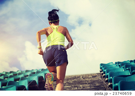 Runner athlete running on stairs.   23740659