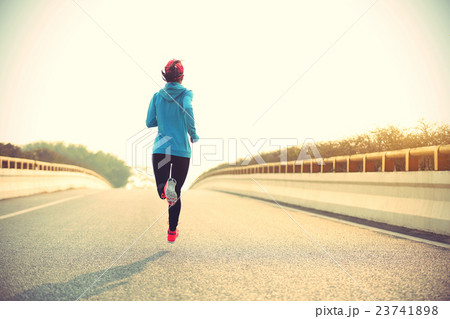 young fitness woman runner running on road young fitness woman runner running on road 23741898