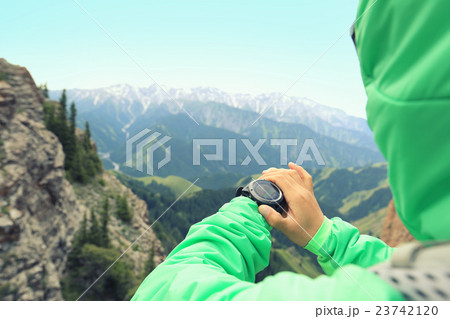 hiker checking the altimeter on sports watch  23742120