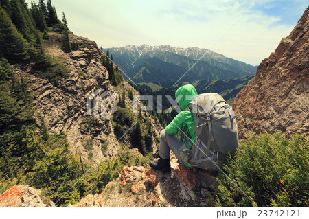 backpacker enjoy the view on mountain peak cliff 23742121