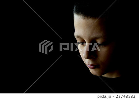 The Sad Boy on a Black Background 23743532