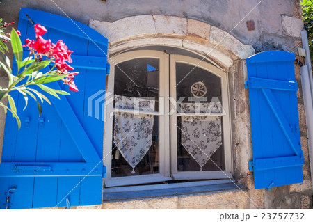 Window with flowers in old house, Provence, France Window with flowers in old house, Provence, France 23757732