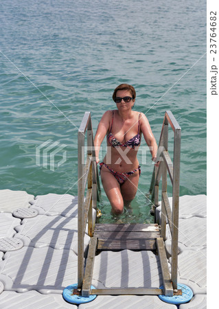 woman swimming in the sea from floating bridge 23764682