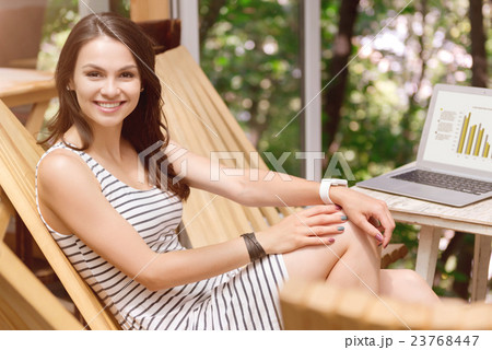 Positive woman sitting in the chair Positive woman sitting in the chair 23768447