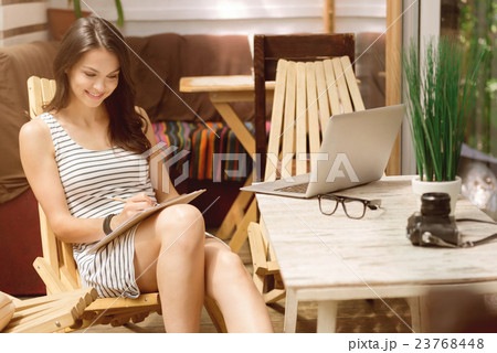 Joyful woman making notes Joyful woman making notes 23768448