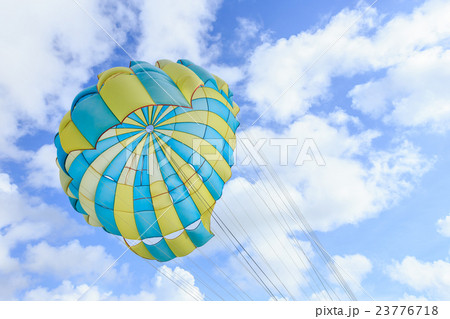Parasailing, beach umbrella on sky background 23776718