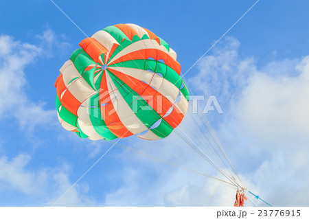 Parasailing, beach umbrella on sky background 23776915