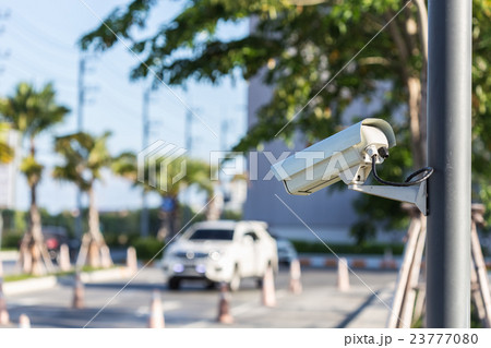 Security CCTV camera operating on the road and blurred of car 23777080