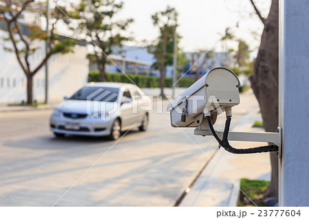Security CCTV camera operating over the road Security CCTV camera operating over the road 23777604