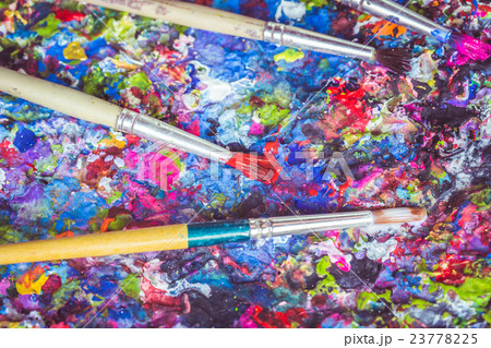 Paintbrush on tray with colorful paint spot on the surface Paintbrush on tray with colorful paint spot on the surface 23778225