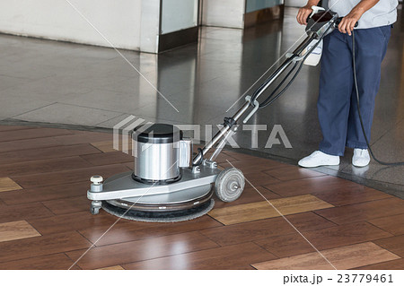 Woman cleaning the floor with polishing machine 23779461