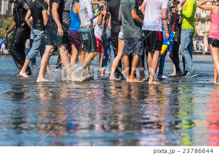 People having fun in a mirror fountain in Bordeaux 23786644