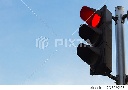 red color on the traffic light with  blue sky i 23799263