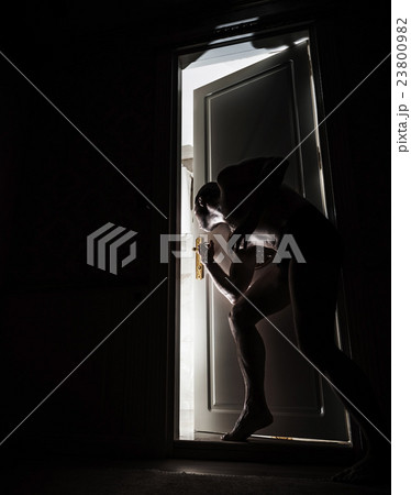 Man peeping through the door slot Man peeping through the door slot 23800982