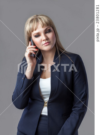 Business woman in suit talking on a cell phone. Business woman in suit talking on a cell phone. 23801281