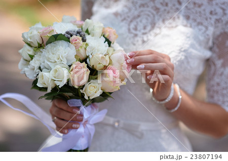 Bride is holding beautiful bright wedding bouquet 23807194