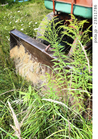 Bulldozer, destroying the plants growing on soil 23811786