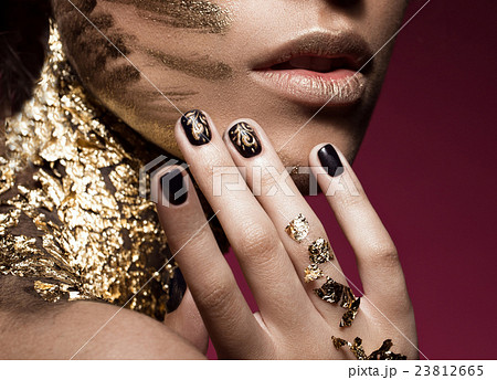Beautyful girl with gold glitter on her face and Beautyful girl with gold glitter on her face and 23812665