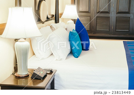 Pillow on bed with light lamp 23813449