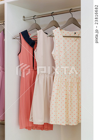 row of colorful dress hanging in white wardrobe row of colorful dress hanging in white wardrobe 23816682